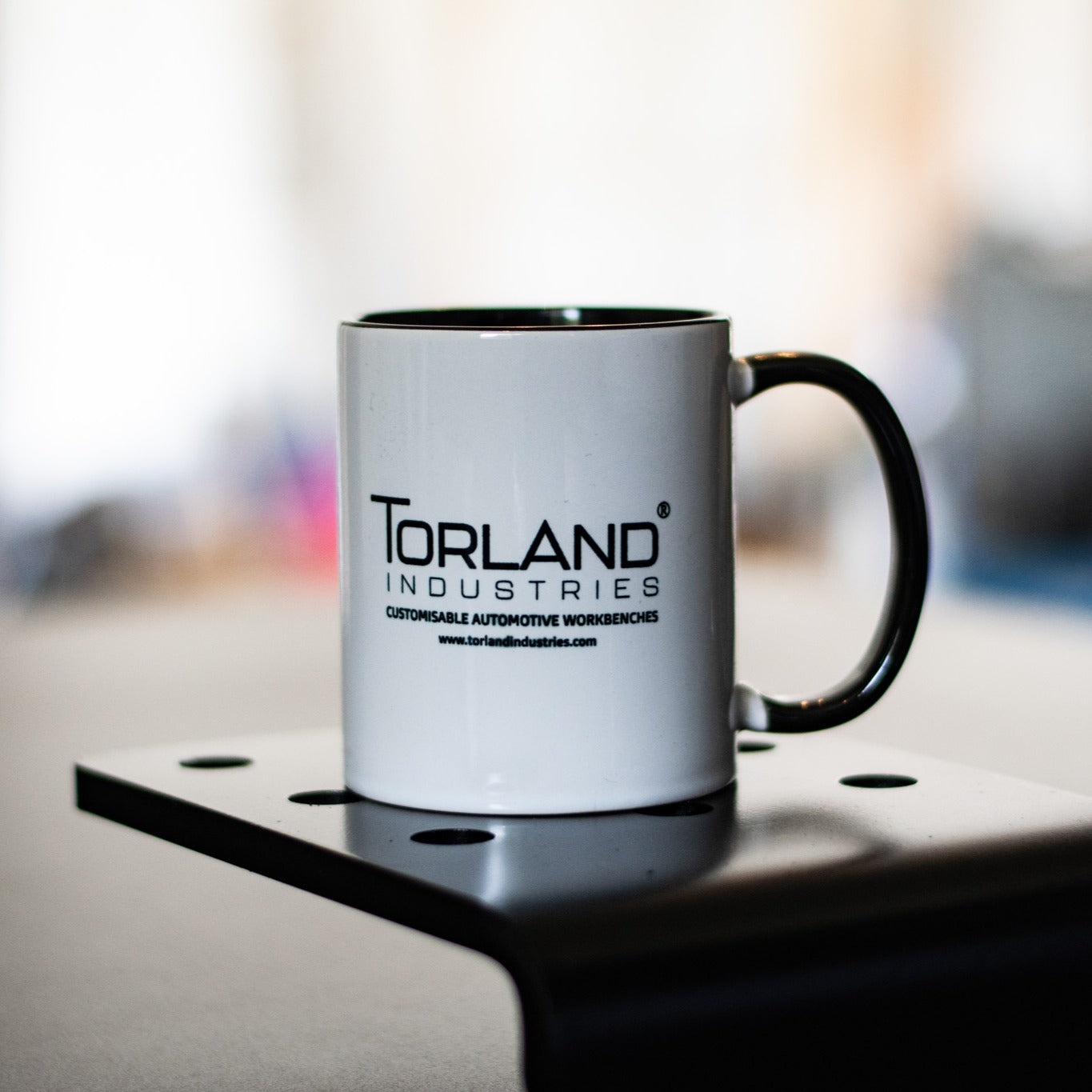 Torland industries mug sitting on a di-lock attachment